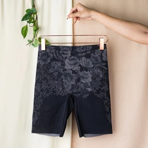 Black Wacoal shaping shorts on a wooden hanger
